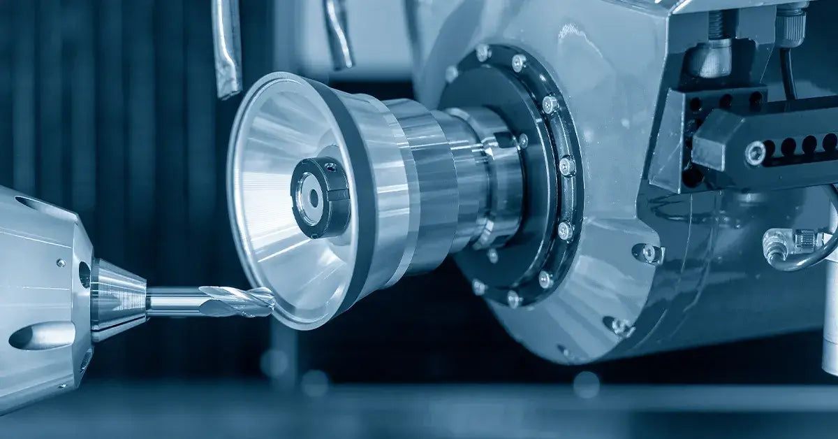 Close-up of a CNC machined aluminum prototype with visible tool marks and clamping fixture on a milling table.